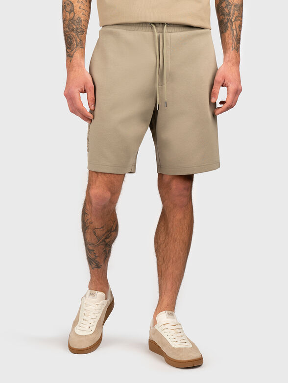 Beige shorts with embossed logo - 1